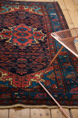 Dargezine rug corner with arabesque spandrels, dragon-like motifs, and its tattered fringe.