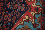 Vintage Dargezine rug with navy herati design meeting red arabesque spandrel, aqua and tan.