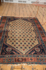 Antique Kurdish Hamadan rug's lower corner with tattered fringe and a floral cross-section spandrel.