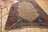 Tattered fringe and worn navy blue border of an antique Kurdish Hamadan rug.