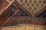 Hard tatter and even wear on the madder root red border of an antique Kurdish Hamadan rug.