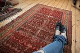 Bright red Persian Malayer runner, serrated leaves, saffron yellow borders, visible wear.