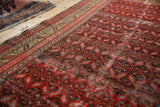 Antique Malayer runner detail: red, brown serrated leaf pattern, geometric border, and aged pile.