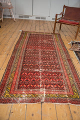 Antique Malayer runner's tattered end with threadbare wear, red and saffron yellow border.