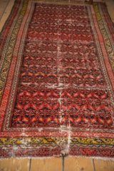 Serrated leaf pattern, visible wear, and tattered end on this antique Malayer runner.