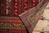 Antique Malayer rug runner with even pile wear, visible foundation, tattered fringe, and secured sides.