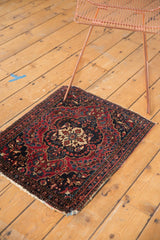Antique Farahan Sarouk rug corner showing significant loss, cherry red, and navy florals.