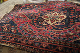 Antique Farahan Sarouk rug: cherry red, navy, ivory scalloped floral medallion.