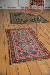Vintage Lilihan runner detail with dusty rose field, blue plants, shrimp motif, and textured secure selvage.