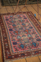 Dusty rose field of Persian Lilihan rug with stylized blue plants, shrimp, and mostly even wear.