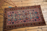 Corner of vintage Lilihan rug runner: dusty rose field, wine red border, and light edge tatter.
