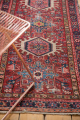 Karaja runner detail featuring geometric medallions in cherry red, sky blue, and ivory.