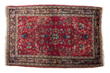 Vintage Lilihan Persian rug with a cherry red field, allover floral vinery, and a dark navy blue border.