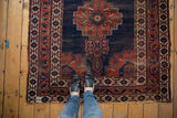 Antique Fine Afshar rug with deep blue field, stepped plant motif, and terracotta borders.