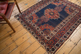 Antique Afshar rug corner detailing contrasting navy, wine red, and ivory patterned borders with light tatter.