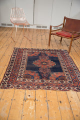Antique Persian Afshar rug, dark blue field, tree-of-life motifs, contrasting red borders.