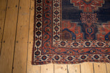 Antique Afshar rug corner: dark blue tree of life motif, contrasting borders, light tatter.