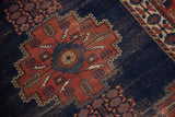 Stepped medallion with potted plants on Fine Afshar rug's dark blue field.