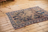 Intricate geometric border of an antique Afshar rug in navy, apricot, and sky blue.