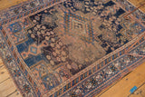 Antique Afshar rug corner with geometric borders in navy, sky blue, apricot, and tattered fringe.