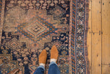 Antique Afshar rug's tribal geometric motifs in navy and apricot, showing border detail and wear.