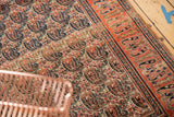 Dynamic paisley boteh pattern and vibrant tangerine-brick red border on vintage Doroksh rug.