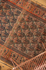 Staggered paisley boteh pattern in tangerine, ivory, navy, camel tones, vintage Doroksh rug.
