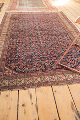 Saturated navy, red, and sky blue tones in the allover Herati motif of an antique Mission Malayer.