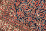 Intricate Herati field and germinating plant border on a finely woven antique Mission Malayer rug.