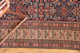 Intricate plant border and navy Herati field of an antique Mission Malayer rug.
