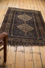 Tattered fringe and geometric patterned border on a vintage Qashqai rug corner.