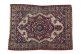 Antique Kermanshah square rug with a scalloped red and navy medallion on an ivory field, 1'10