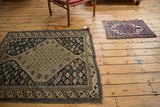 Antique Kermanshah mat shown to scale, featuring a cochineal red and ivory roundel medallion.