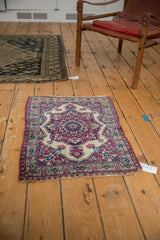 Antique Persian Kermanshah rug mat styled in a room for decorative scale.