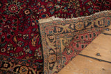 Vintage Lilihan rug's hand-knotted reverse weave, deep red pile, and uneven fringe.