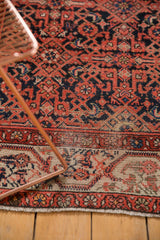 Vintage Malayer rug's low pile texture, showing navy Herati field and Serbend border.