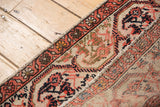 Malayer rug's secured side, low pile, Herati motif, and exposed woven foundation.