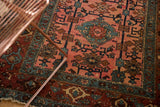 Antique Lilihan rug showing low pile border with samovar motifs and dusty raspberry field.