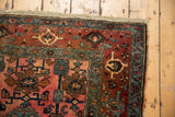Antique Lilihan rug corner detail, highlighting samovar border motifs, deep reds, and tattered side.