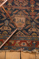 Tattered fringe and worn low pile on the madder red Hamadan rug border.