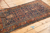 Antique Kurdish Hamadan rug edge details: indigo field with herati motif, madder red border, and visible tatter.