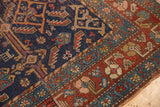 Antique Kurdish rug border with indigo field, madder red, and serrated leaf motifs.