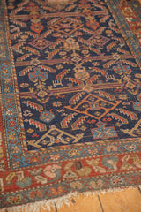 Worn indigo field, madder red border, and tattered fringe on antique Kurdish Hamadan rug.