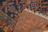 Antique Kurdish Hamadan rug's indigo blue geometric pile, revealing woven foundation and tattered fringe.