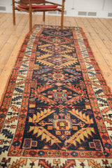 Intricate tribal geometric pattern with madder red border on this antique Northwest Persian runner.