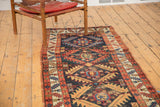 Northwest Persian runner detail, shadow medallion lattice with time-softened navy, red, gold pile.
