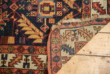Antique Northwest Persian runner corner: dark navy field, gold serrated leaves, geometric border.