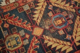 Detail of antique Northwest Persian runner's navy field and madder red serrated leaf lattice.