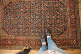 Finely knotted antique Fereghan rug with intricate herati pattern in indigo and madder red.