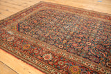 Intricate Herati motif on a fine-knotted Persian Fereghan rug in indigo, red, and saffron.